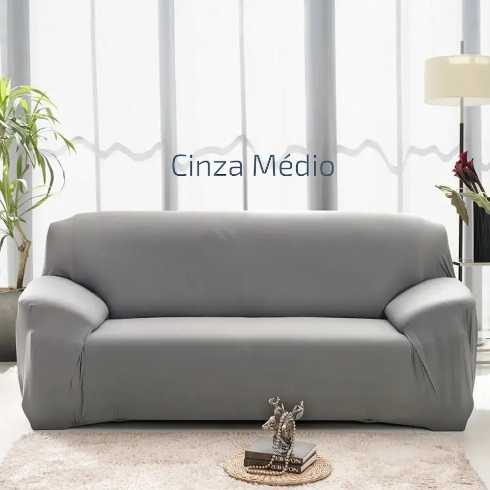 Imagem de uma sala clara com um sofá cinza médio. Ao lado esquerdo, há uma planta, e à direita, uma luminária de chão. Texto central: "Cinza Médio". Uma pequena mesa de centro com livros e uma escultura está à frente do sofá.